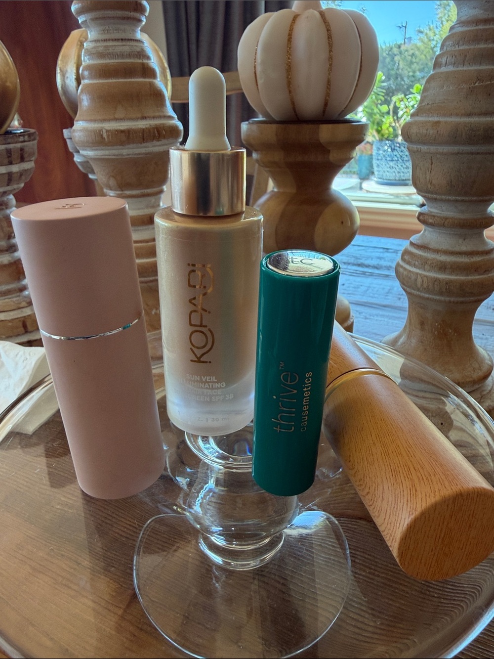 Kopari Illuminating Sun Veil Serum — Cream / Gold Accents. Various items include